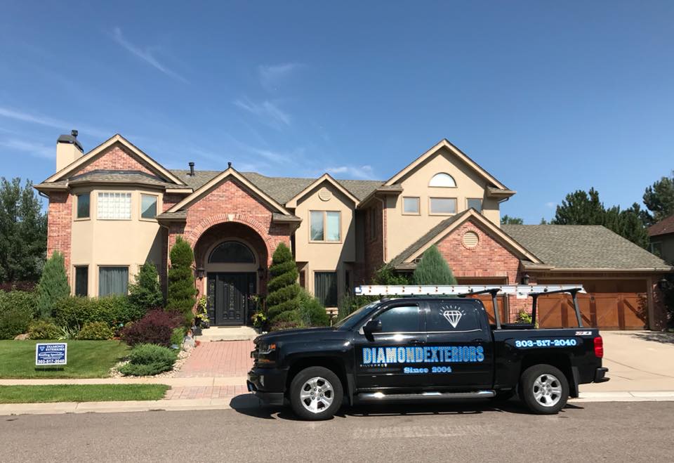 Diamond Exteriors truck parked in front of a residential home