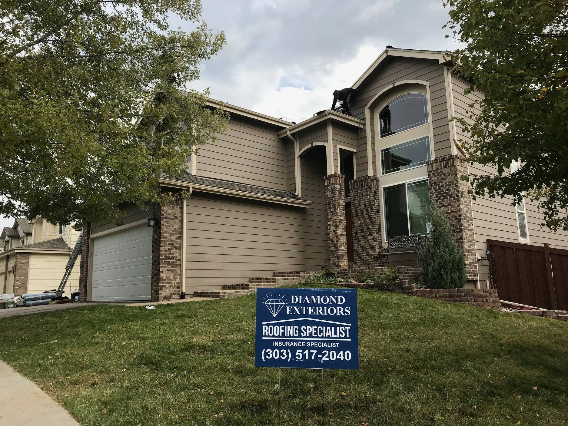 Castle Rock home with Diamond Exteriors yard sign from roofing projects