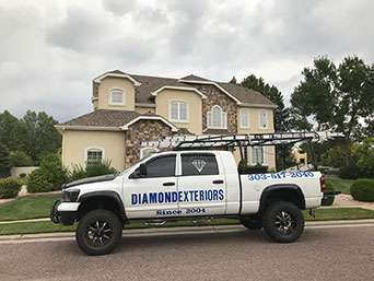 Diamond Exteriors truck parked in front of a residential home