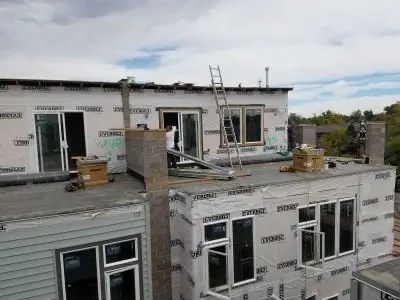 Roof and siding being replaced on apartment building by highly rated company called diamond exteriors